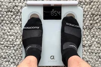 An overhead view of a person standing on the Arboleaf CS10E Segmental Body Scale