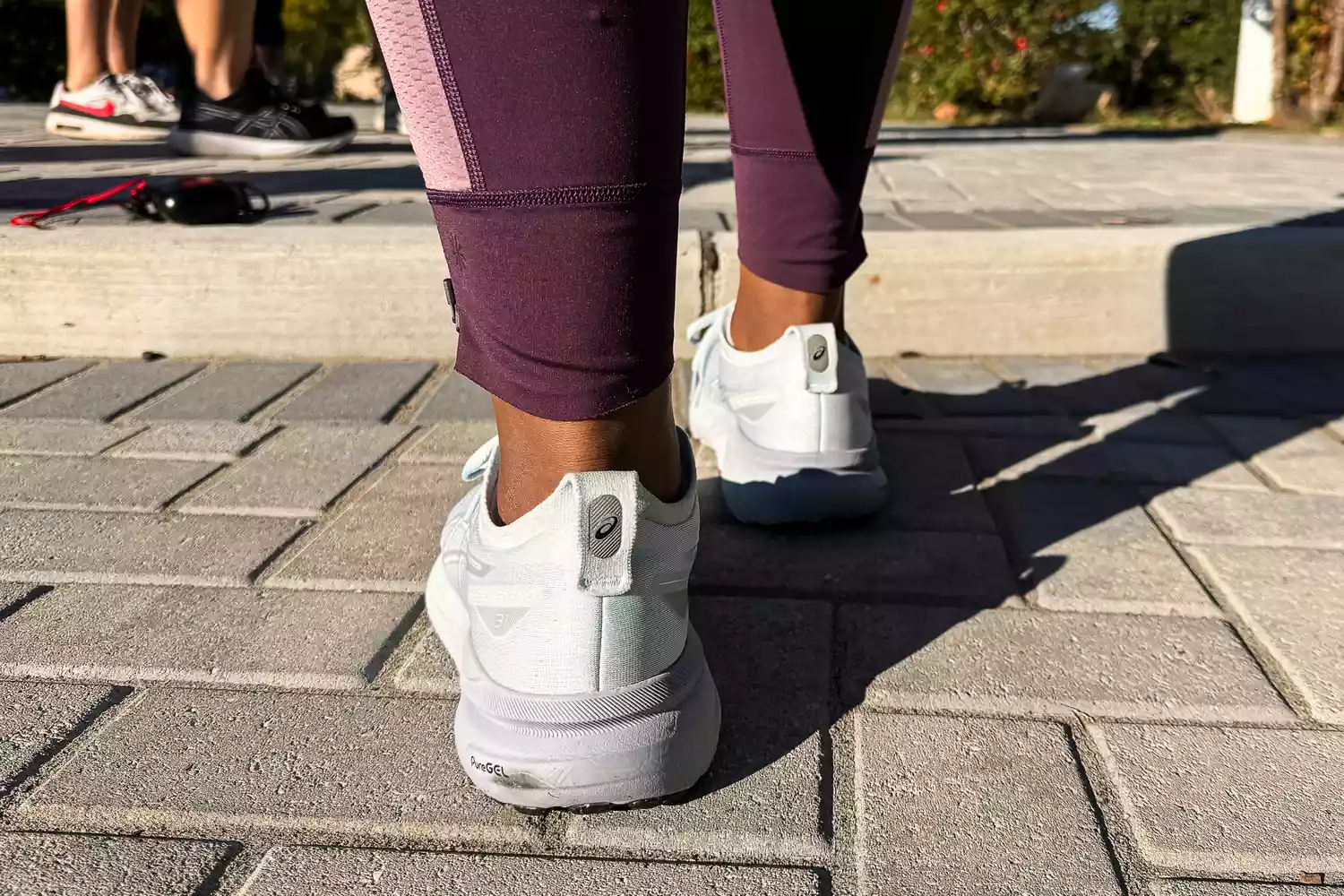 The back of a person wearing the Asics Women's Gel-Kayano 31 Running Shoes
