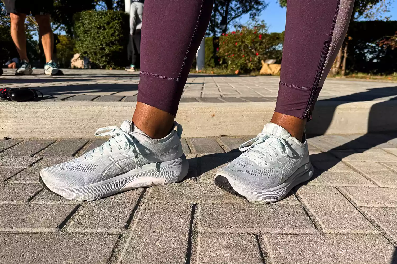 A person stands outside while wearing the Asics Women's Gel-Kayano 31 Running Shoes