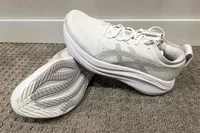 Two Asics Men's GEL-NIMBUS 27 sneakers posed on carpet