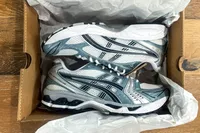 A pair of Asics Men's Gel-Kayano 14 Sneakers in a shoebox