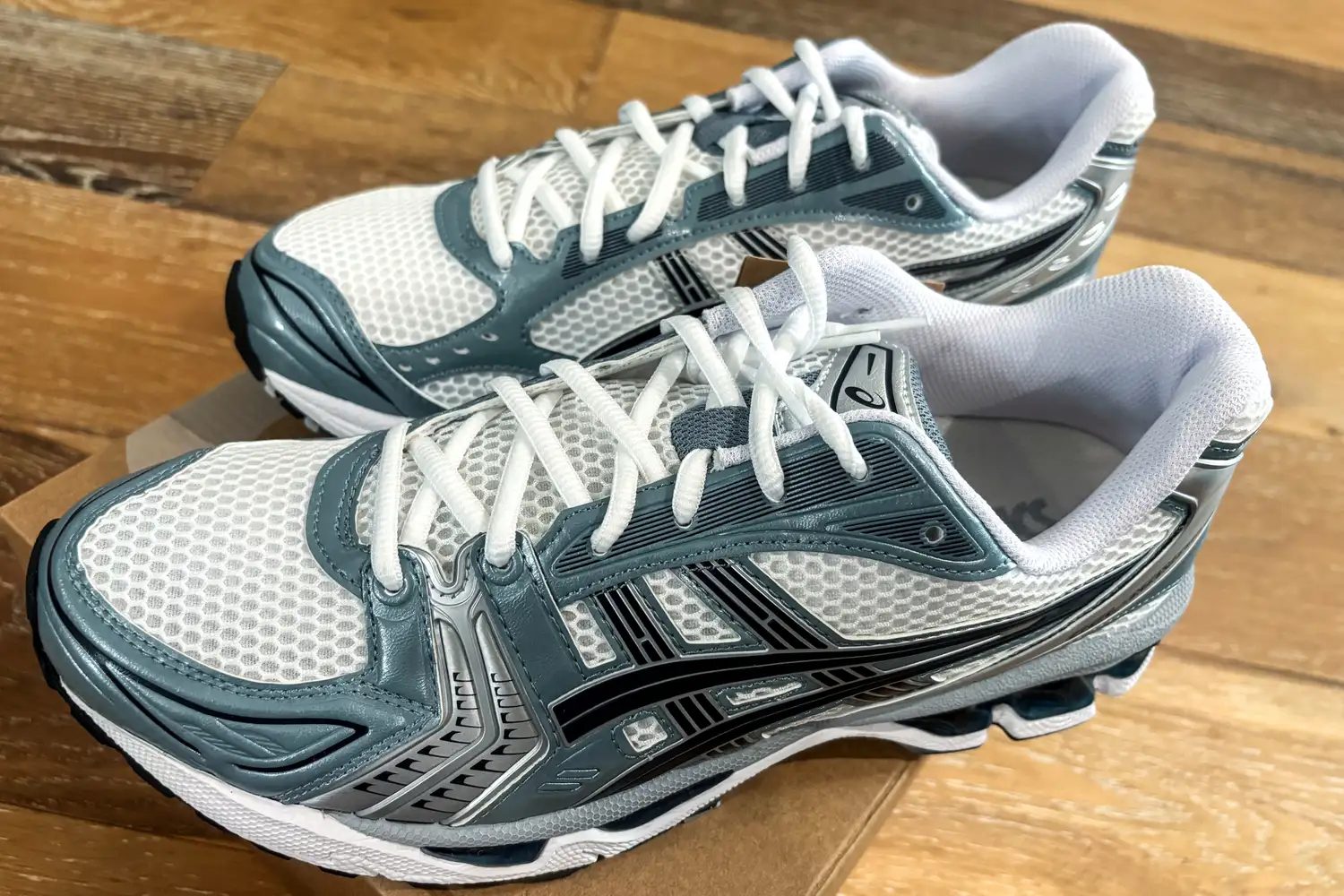 An overhead view of the Asics Men's Gel-Kayano 14 Sneakers on a wooden floor