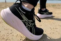Woman wears Asics Women's Gel-Nimbus 26 walking on sand