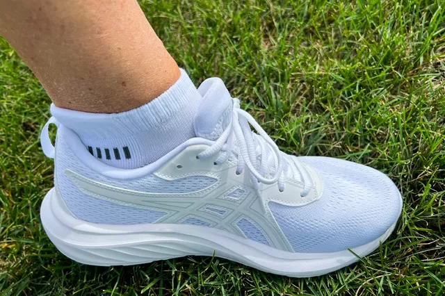 A person wears the Asics Women's Gel-Contend 9 Walking Shoes in grass