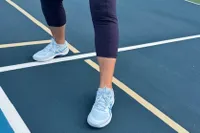 A person wears the Asics Women's Game FF Pickleball Shoes while playing pickleball