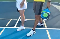 A person wears the Asics Women's Game FF Pickleball Shoes on a pickleball court
