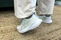 A side view of a person wearing the Asics Women's Gel-Cumulus 27 Running Shoes
