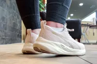 A close-up of the back of a foot wearing the Asics Women's GEL-Pulse 16 on tile