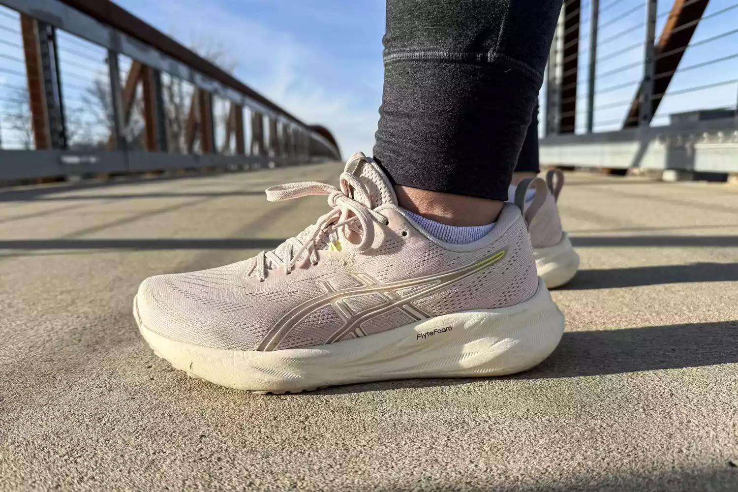 The Asics Women's GEL-Pulse 16 worn on a bridge viewed at a side angle