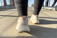 A close-up of the back of a person's foot as they walk in the Asics Women's GEL-Pulse 16