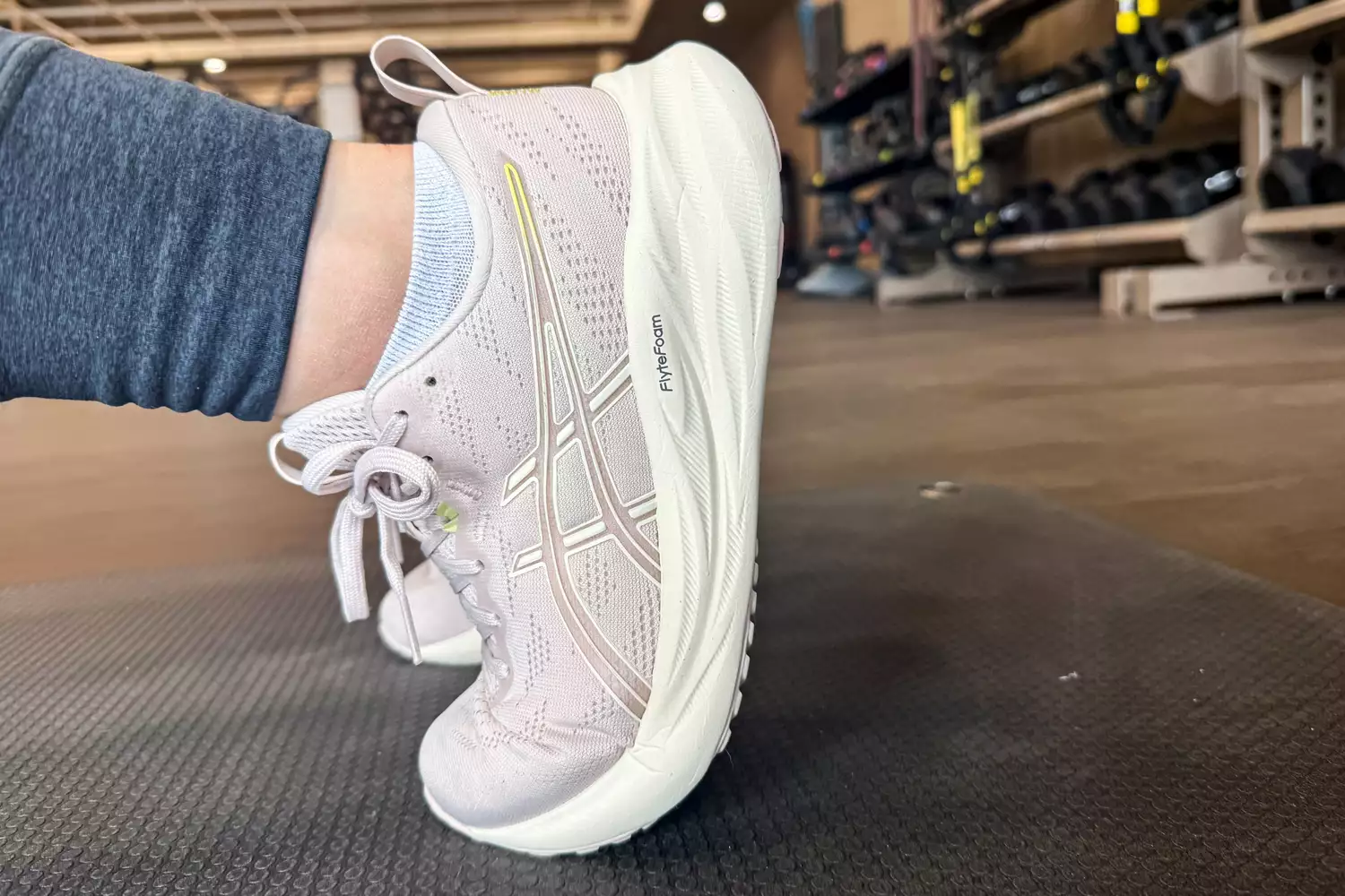 A close-up of the Asics Women's GEL-Pulse 16 worn on a mat in a gym