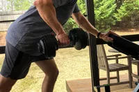 A person lifts the Ativafit Adjustable Dumbbell Set
