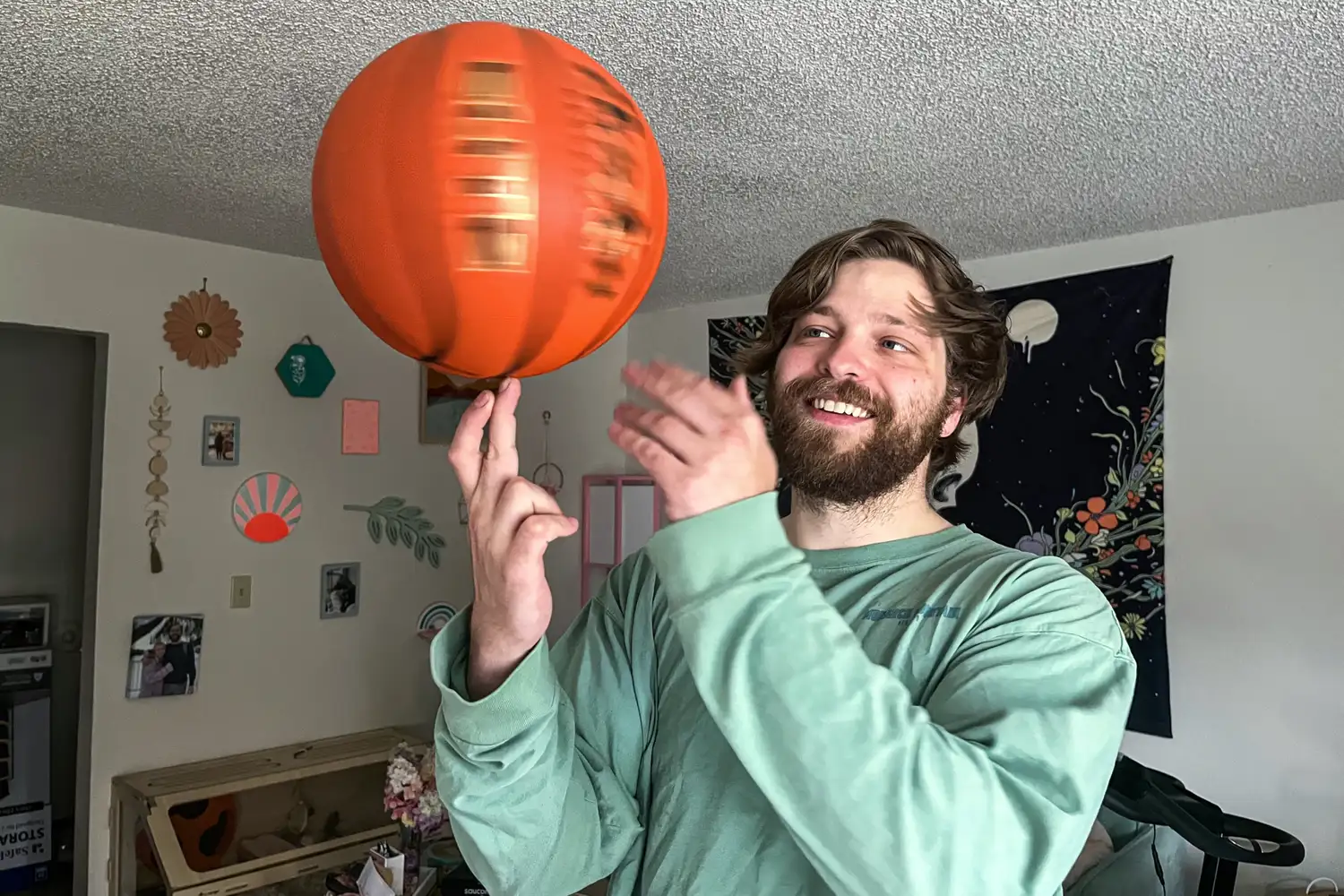 A person spins the Baden Elite Game Basketball on their finger