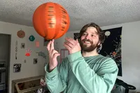 A person spins the Baden Elite Game Basketball on their finger