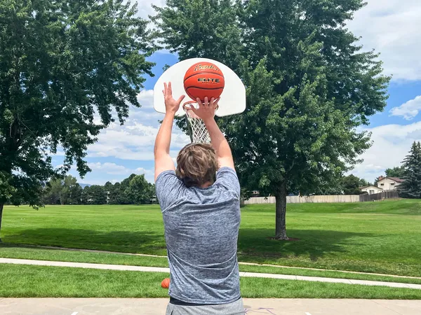 A person shoots the Baden Elite Game Basketball