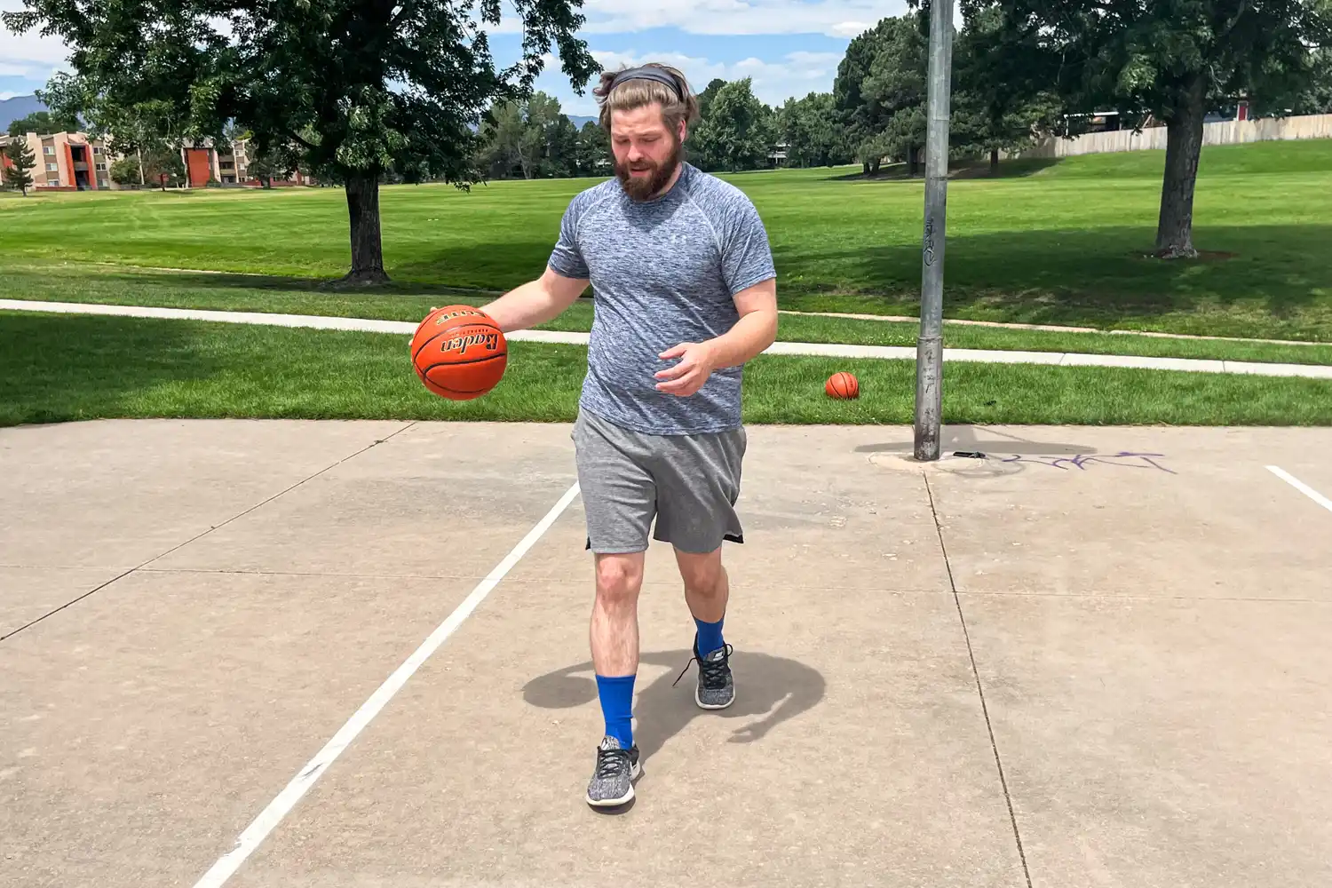 A person dribbles the Baden Elite Game Basketball