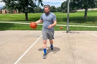 A person dribbles the Baden Elite Game Basketball