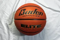 The Baden Elite Game Basketball on a bed