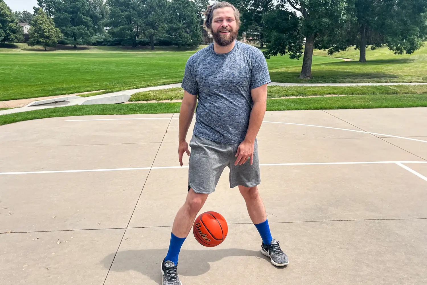 A person dribbles the Baden Elite Game Basketball between their legs