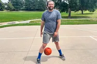 A person dribbles the Baden Elite Game Basketball between their legs