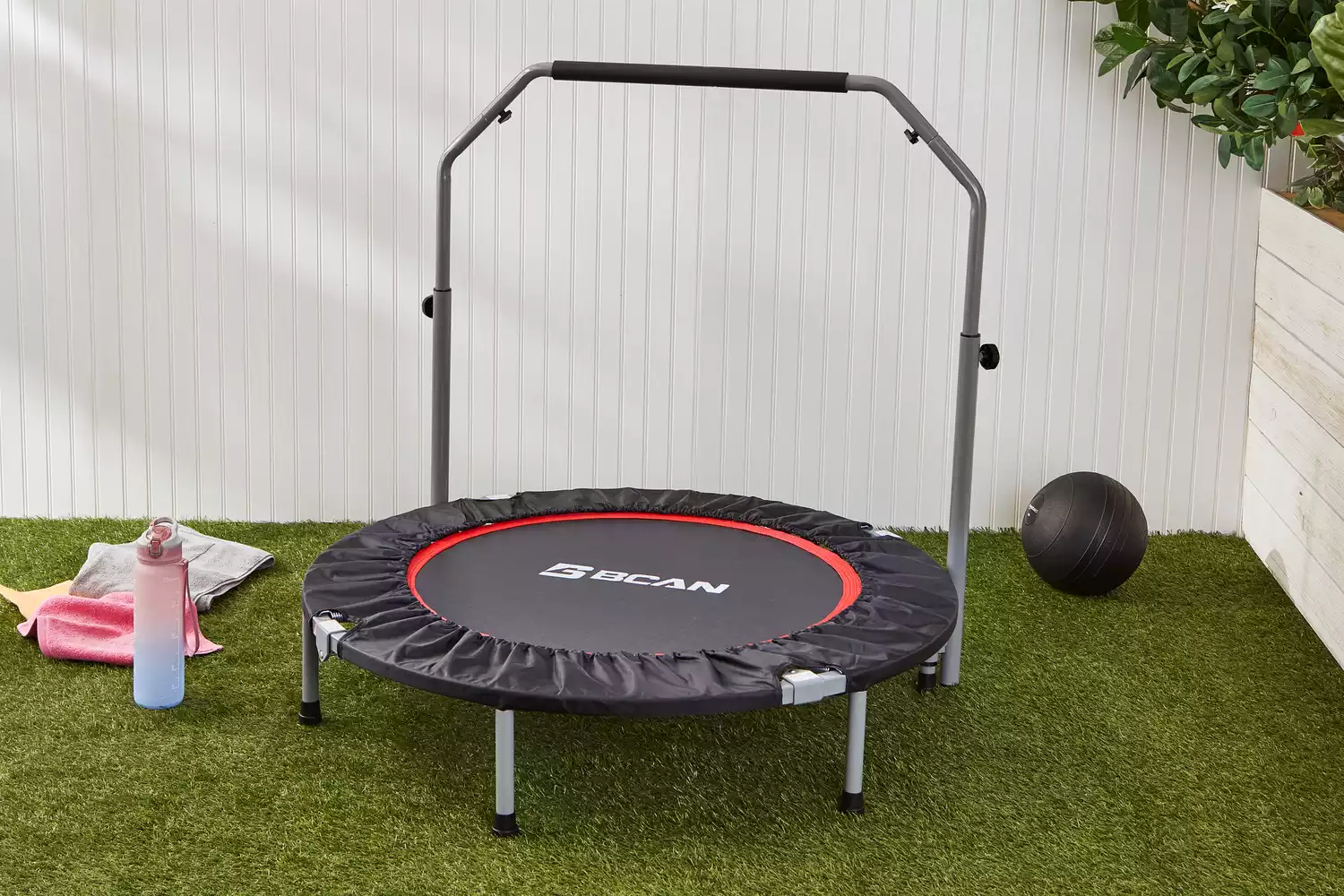 BCAN Foldable Mini Trampoline displayed on lawn next to ball and water bottle