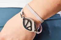 The Bellabeat Leaf Urban Smart Jewelry Health Tracker is worn on a person's wrist