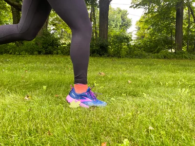 A close-up of a person running in Brooks Cascadia 17 shoes