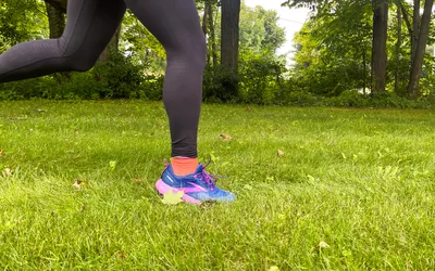 A close-up of a person running in Brooks Cascadia 17 shoes