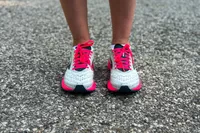 Two feet posed while wearing Brooks Hyperion Tempo Road-Running Shoes on black top