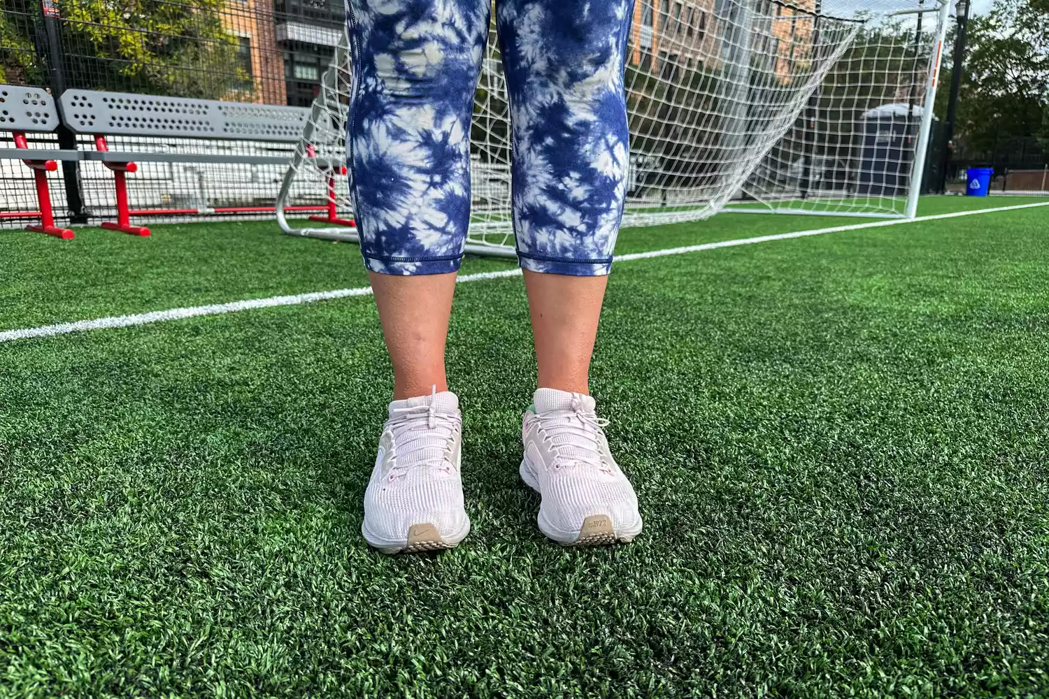 A person wearing Nike Womenâs Pegasus 40 shoes on a soccer field