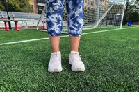 A person wearing Nike Womenâs Pegasus 40 shoes on a soccer field