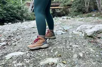 Person wearing Columbia Women’s Newton Ridge Plus Hiking Boots standing on rocky ground