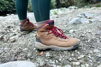 Person wearing Columbia Women’s Newton Ridge Plus Hiking Boots standing on rocky ground