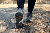 Person walking on a trail wearing KEEN Targhee III Mid Waterproof Hiking Boots