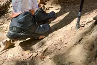 Feet wearing Salomon X Ultra 4 Mid Gore-tex Boots on a dirt trail