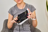 Person bending the front of a Adidas Women's Cloudfoam Qt Racer Running Shoe