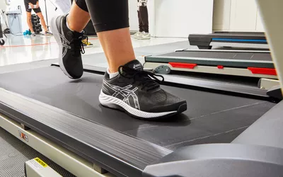 Person on treadmill wearing Asics Gel-Excite 9 Women's Running Shoe