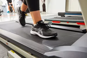 Person on treadmill wearing Asics Gel-Excite 9 Women's Running Shoe