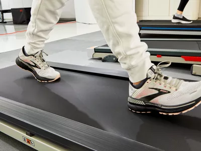Person wearing Brooks Adrenaline GTS 22 shoes walking on a treadmill