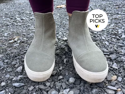 Toms Fenix Platform Chelsea Boots being worn on a stone path