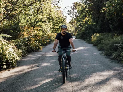 A person rides the Mongoose Colton Mens and Womens Mountain Bike