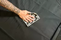 A hand holding patterned cloth to the Bon Charge Infrared Sauna Blanket