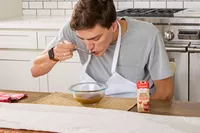 A person sips on Kitchen Basics Turmeric & Ginger With Lemongrass Chicken Bone Broth