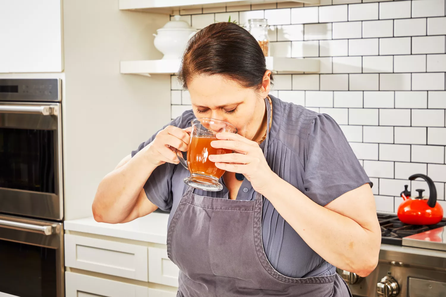 A person sips Kettle & Fire Bone Broth 