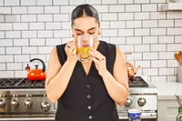 A person drinks Swanson Sipping Chicken Bone Broth