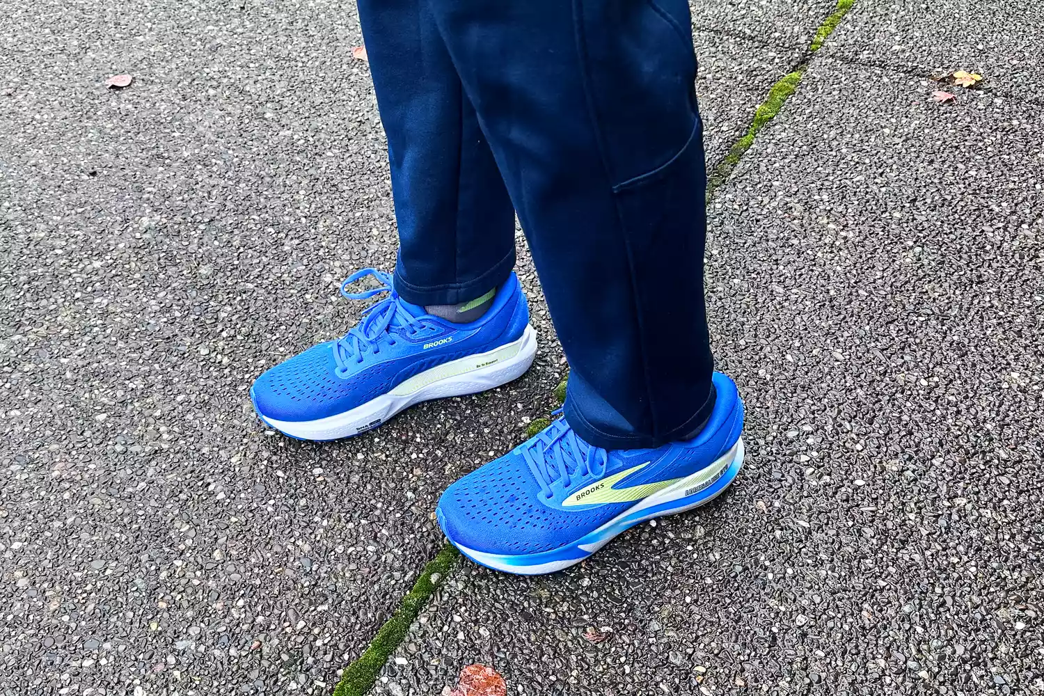 A person walks outside while wearing the Brooks Men's Adrenaline GTS 24 Road Running Shoes