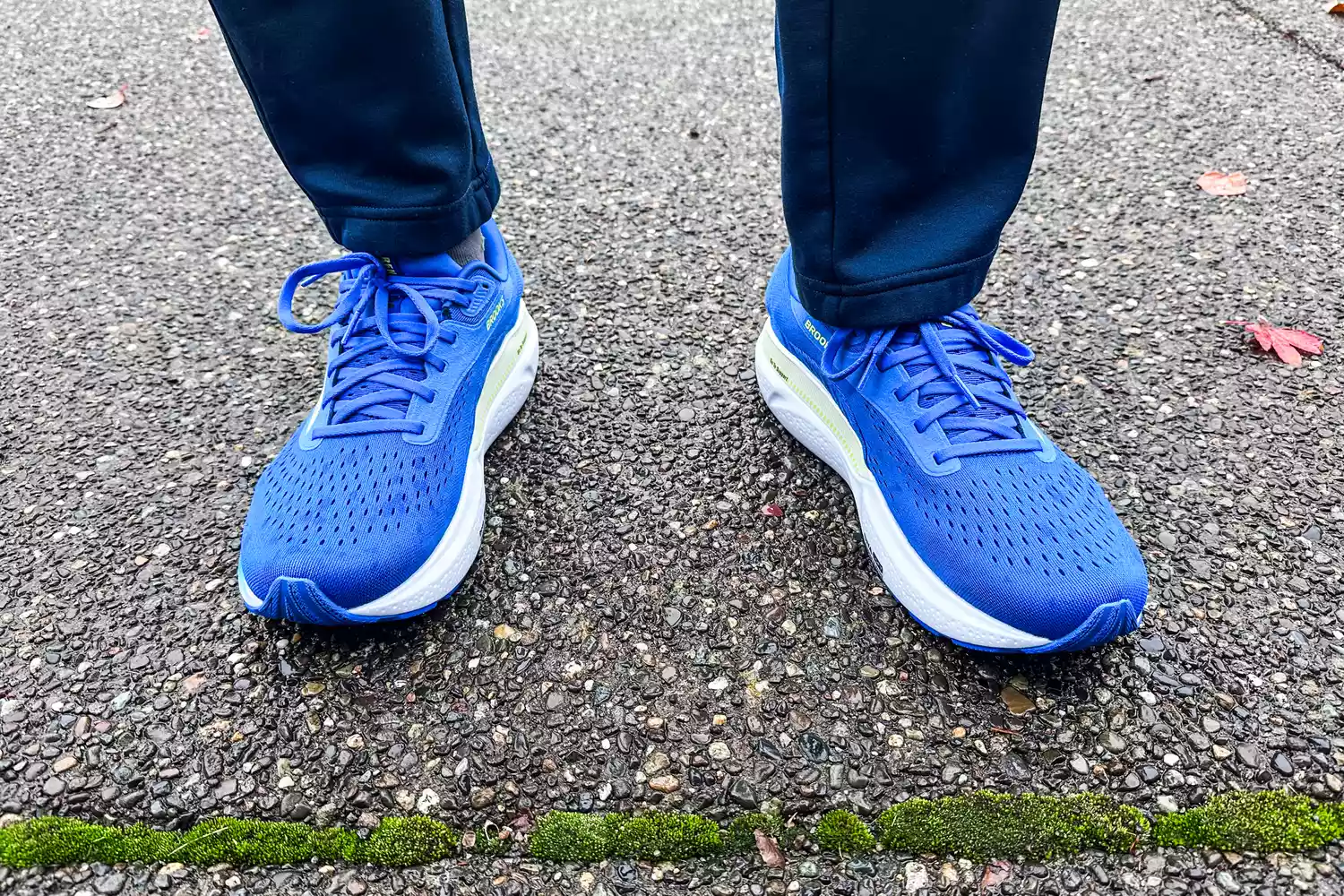 A person wears the Brooks Men's Adrenaline GTS 24 Road Running Shoes while walking outside
