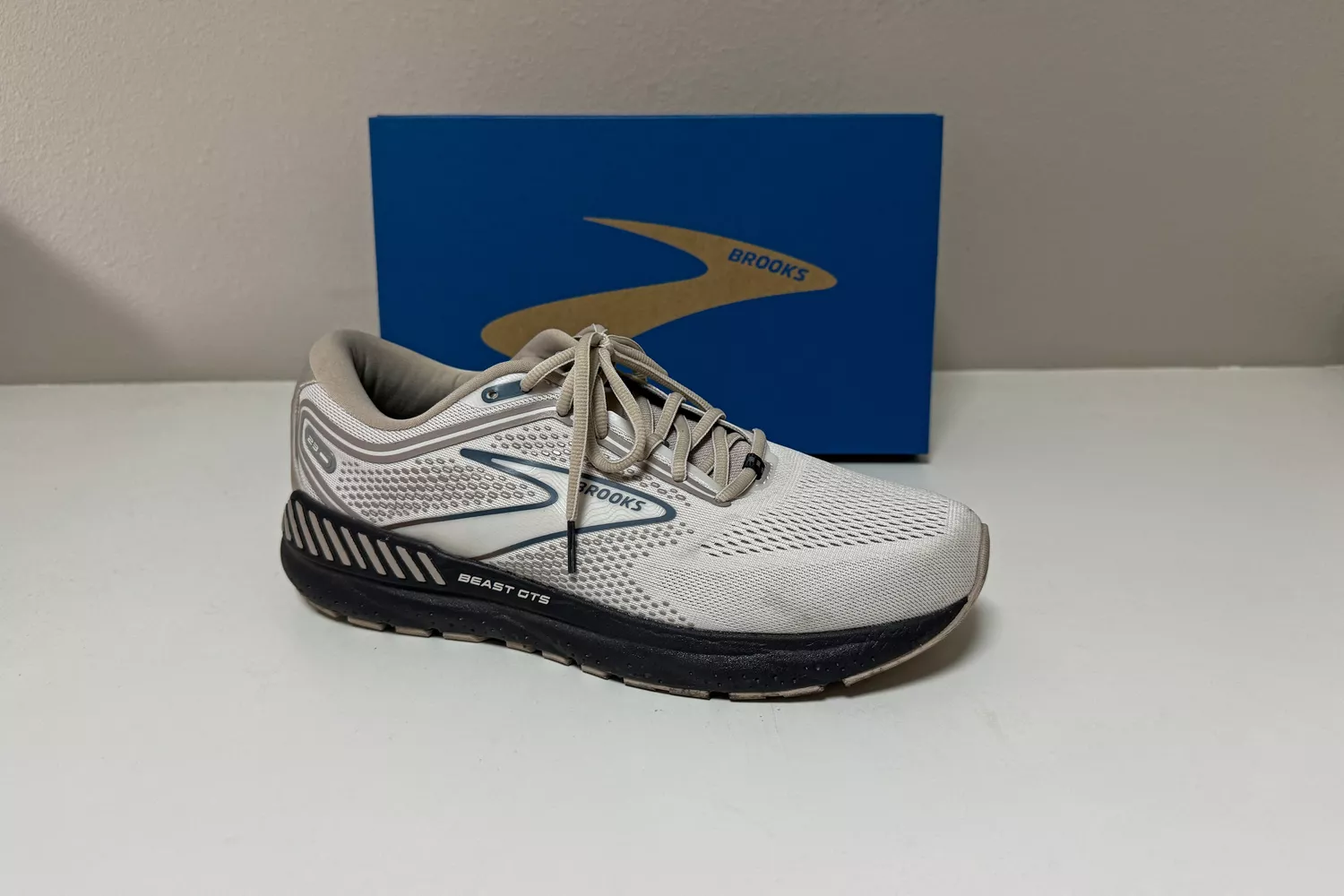 The Brooks Men's Beast GTS 23 Running Shoe in front of its box