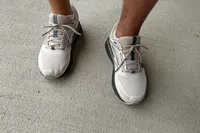 An overhead view of a person wearing the Brooks Men's Beast GTS 23 Running Shoe outside on concrete