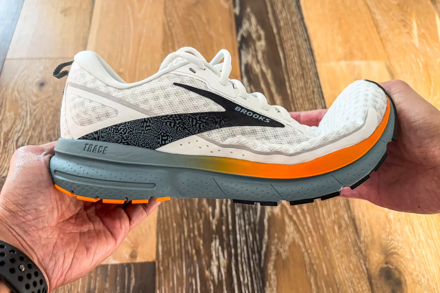 A person folds the toe of the Brooks Men's Trace 3 Road Running Shoes